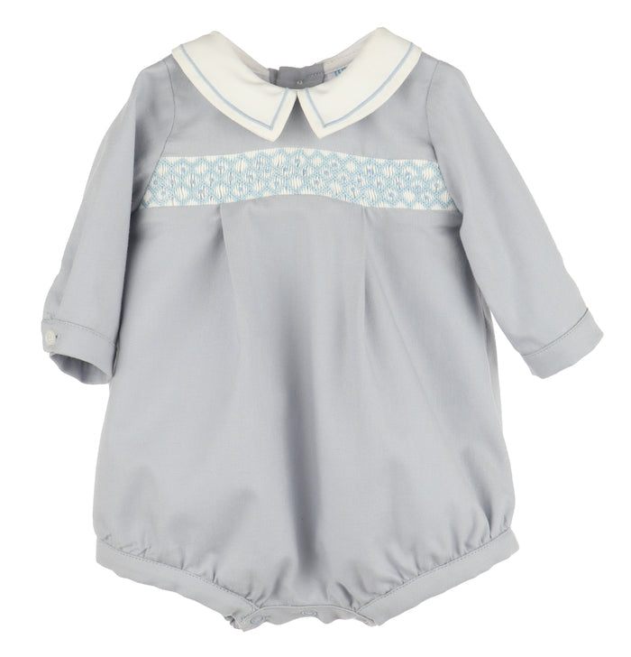 Crafted for timeless charm, this Infant Boys Dusty Blue Smocked Bubble features a classic Peter Pan collar with delicate embroidered borders. The front showcases hand-smocked embroidery, adding a refined touch perfect for special occasions or memorable photo milestones.